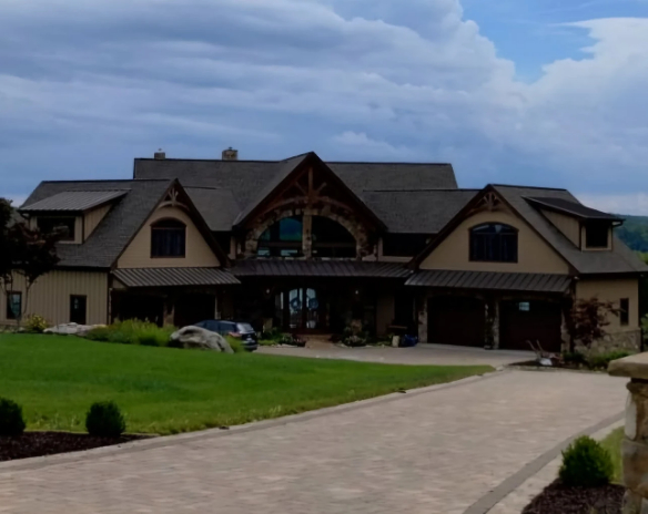 Large residential home side view with clean siding and windows
